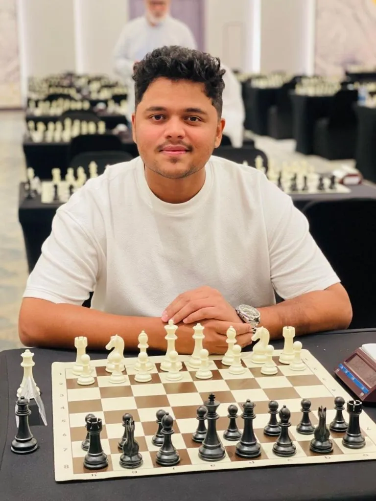 Chess instructor NM Dilshad Mohammed at a chessboard